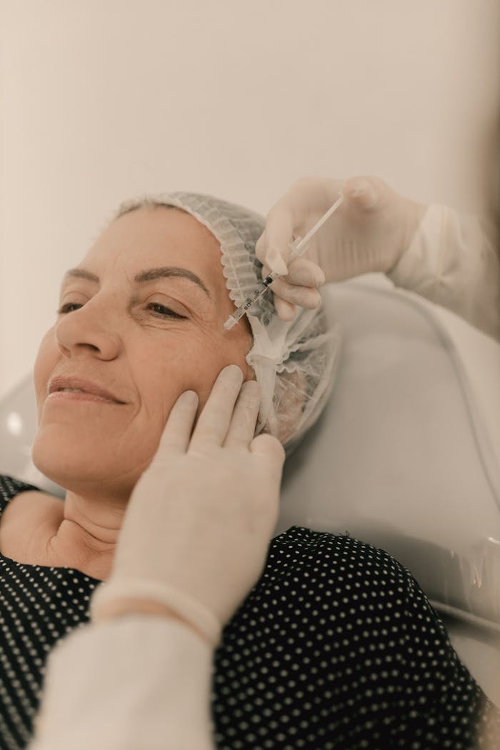 A woman undergoing a facial injection treatment in a medical setting, emphasizing skincare and aesthetics.